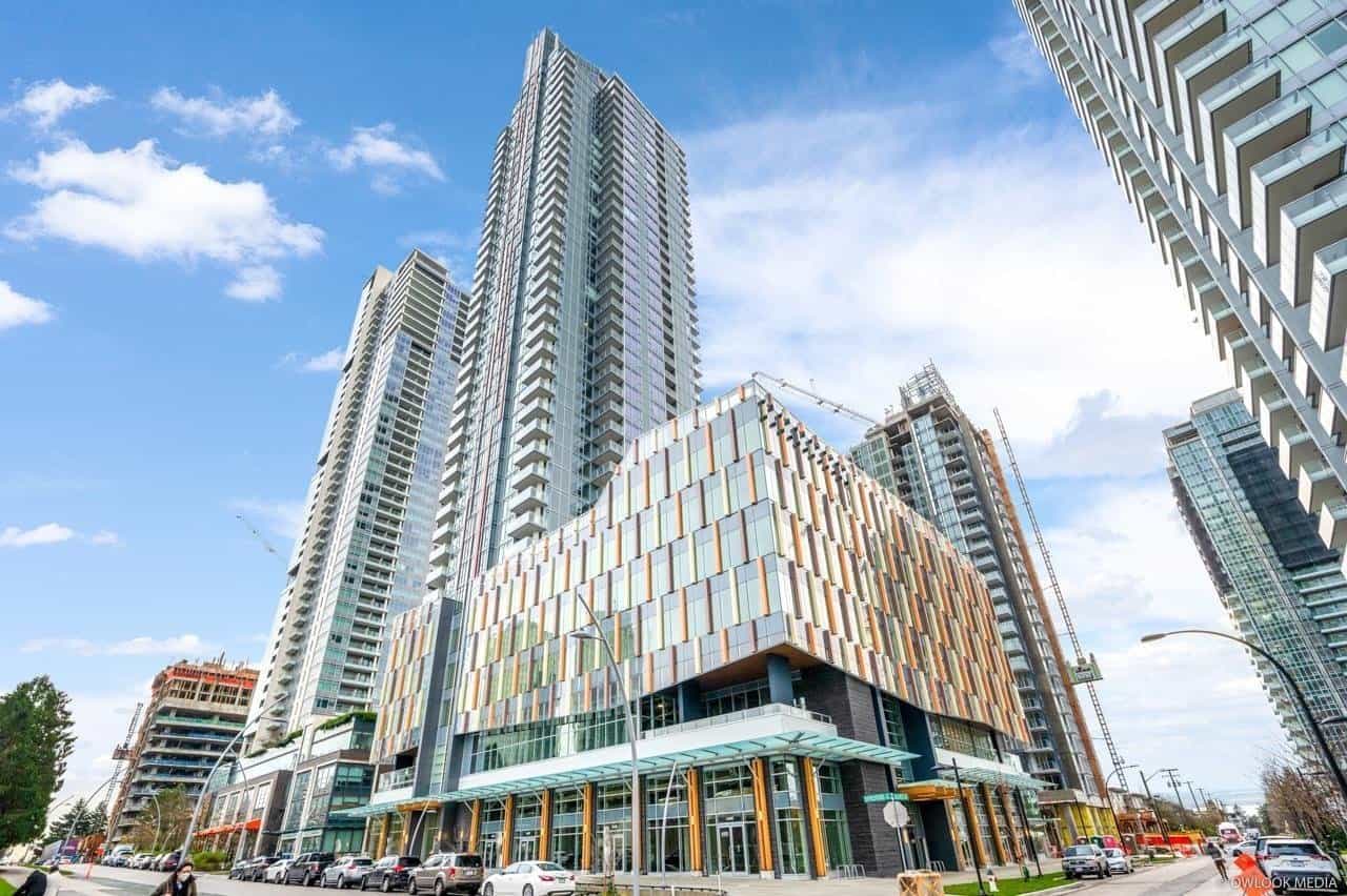 Modern high-rise condominiums in downtown Vancouver with retail space on the ground level, eco-friendly architecture, and scenic city views, available through Orca Realty Inc.