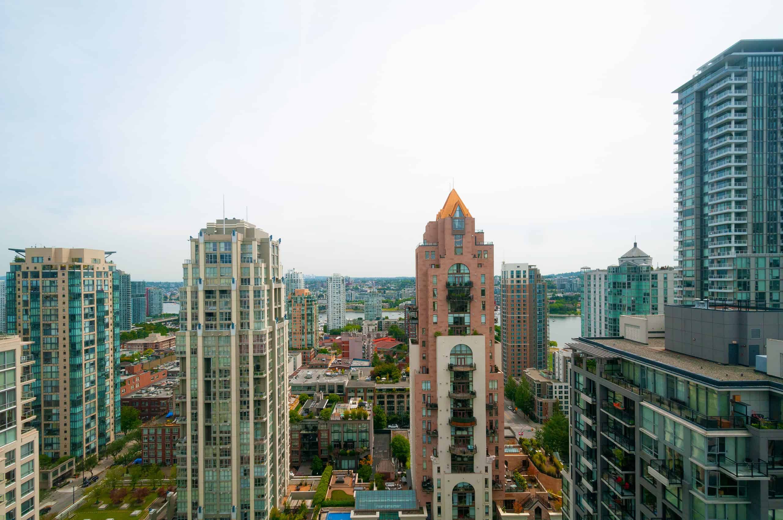 040 Luxurious high-rise apartment buildings with city skyline views in downtown Vancouver, showcasing modern condos and waterfront living associated with Orca Realty Inc.