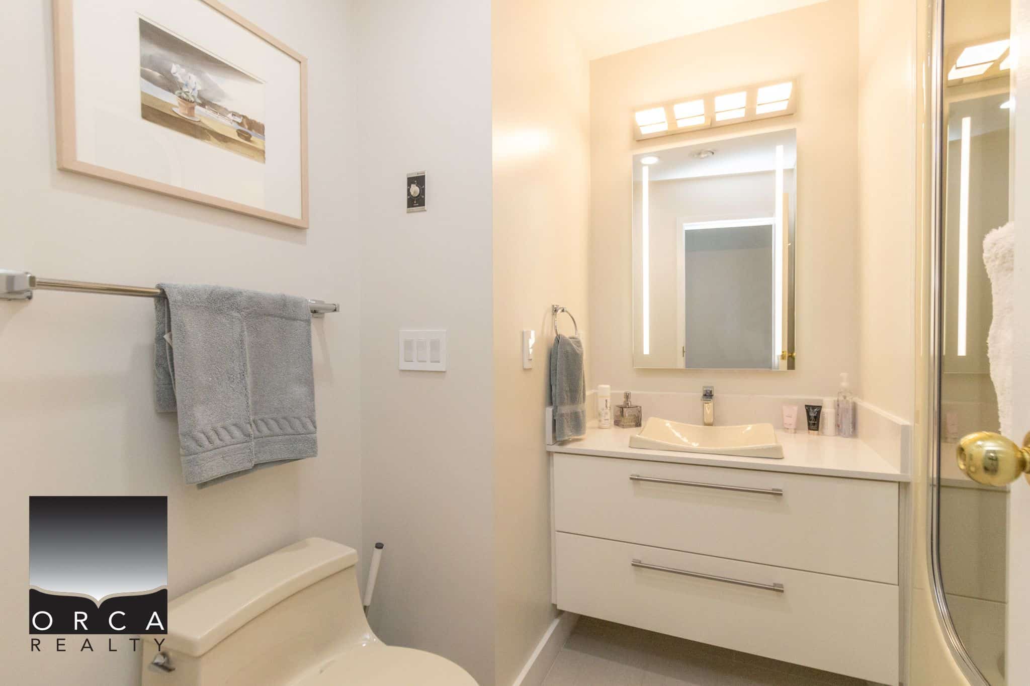 Modern bathroom interior with white vanity, rectangular mirror, and shower stall, showcasing contemporary home design ideal for Vancouver real estate.