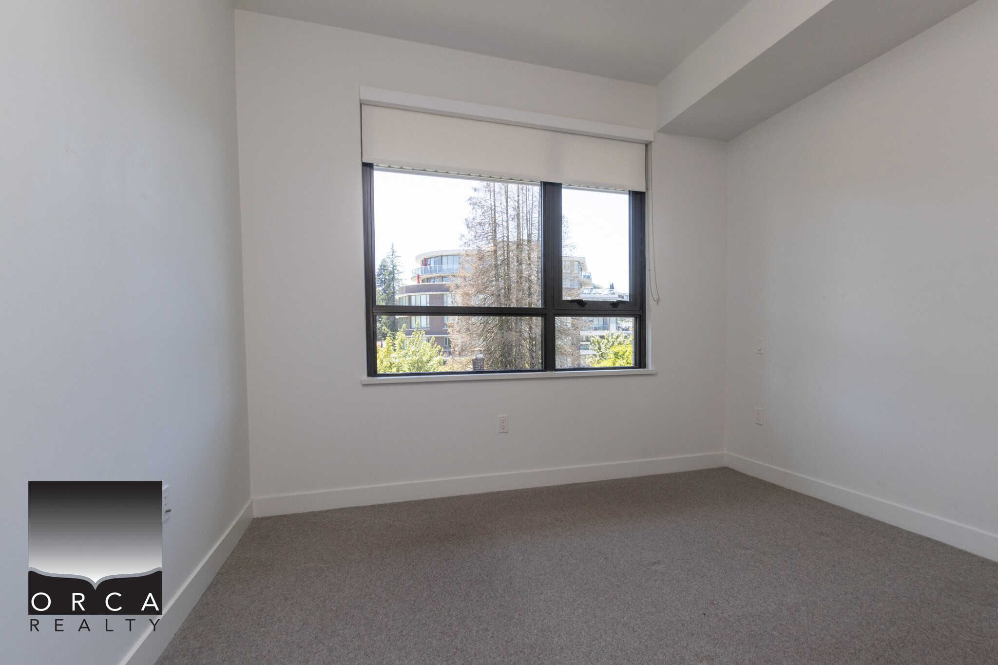 Bright vacant rental apartment with large window showcasing city views in Vancouver, BC. Ideal for first-time homebuyers or tenants seeking modern, move-in ready condo with natural light.