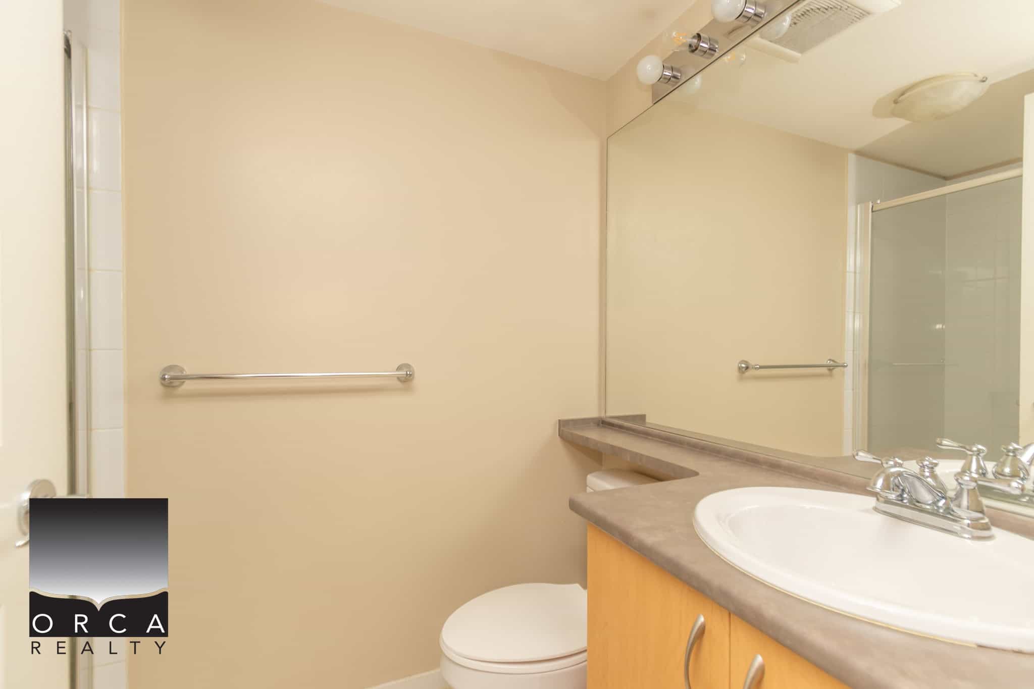 Bright bathroom with modern fixtures and neutral decor, perfect for Vancouver Island homes, available for sale or rent through Orca Realty Inc.
