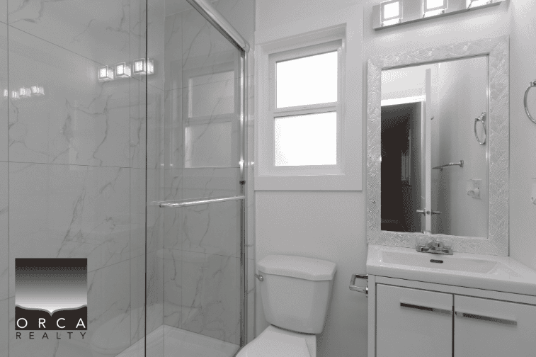Shower and bathroom fixtures in modern home, bright white walls, marble tiles, large mirror, clean and sleek design, natural light from window, minimalistic style, plumbing details, contemporary interior decor.