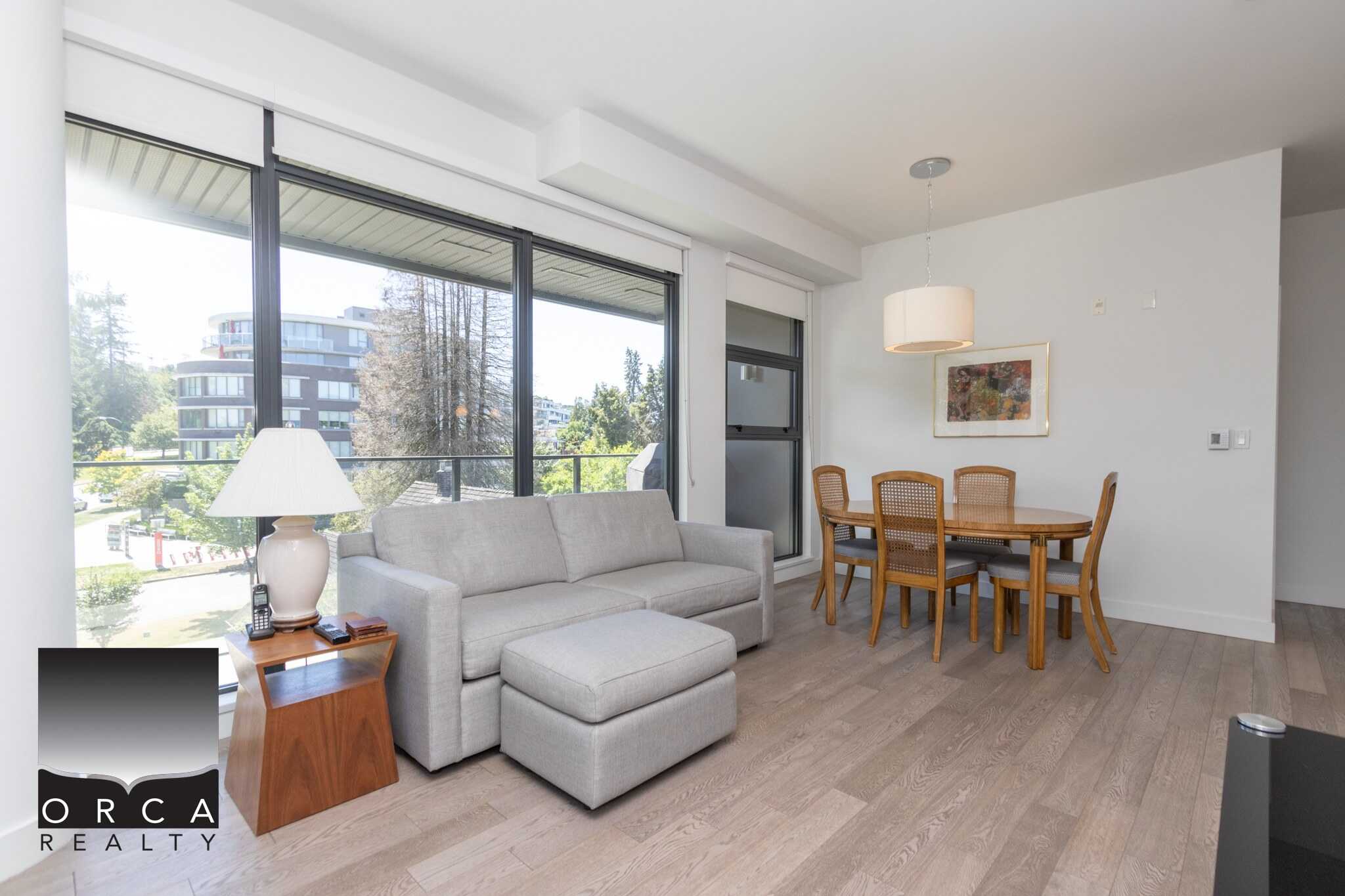 Bright Vancouver condo living room with large windows, modern furnishings, and open layout, perfect for comfortable urban lifestyle.