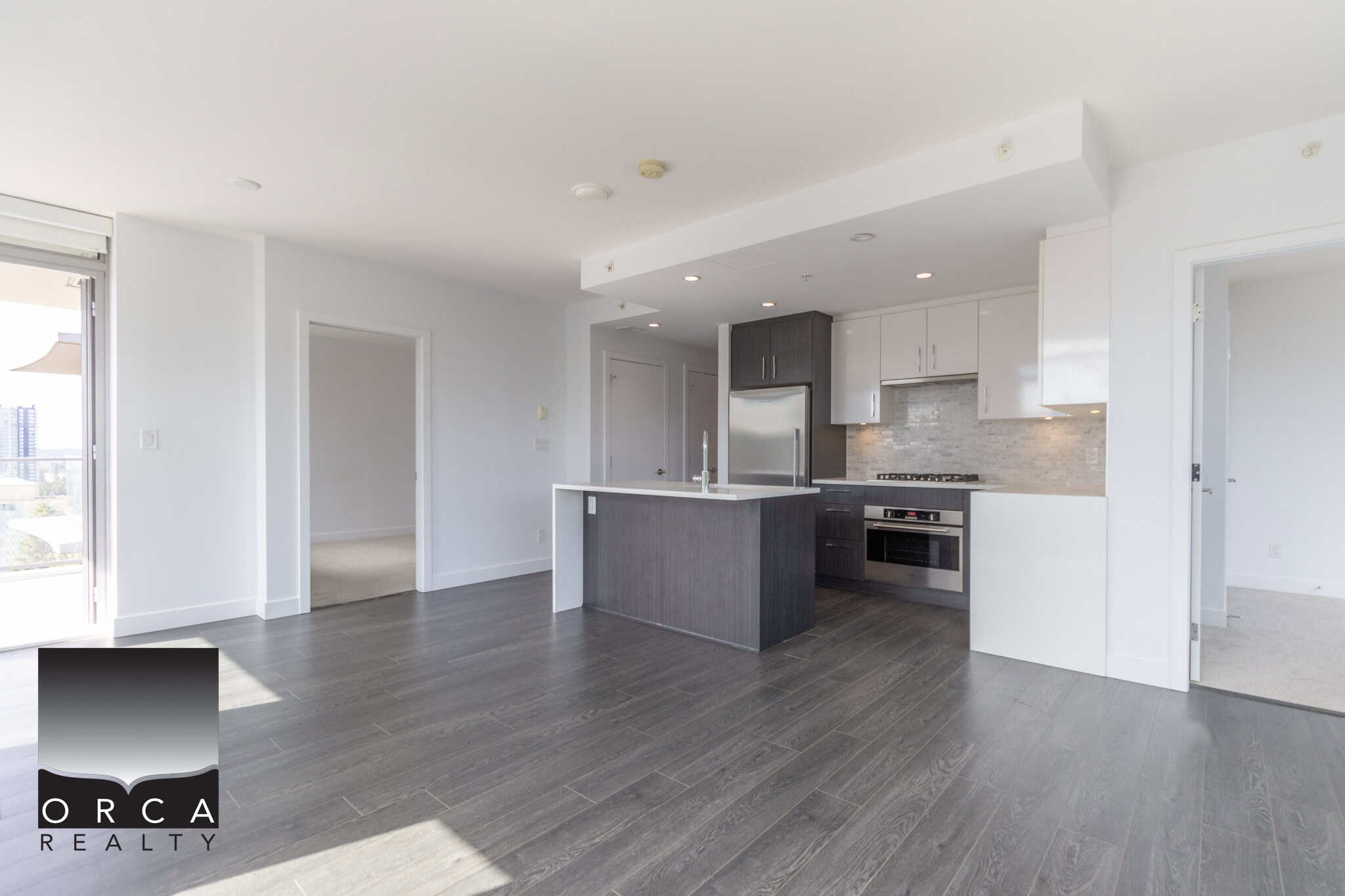 Modern open-concept kitchen with sleek cabinetry, stainless steel appliances, and contemporary design, perfect for upscale Vancouver real estate.