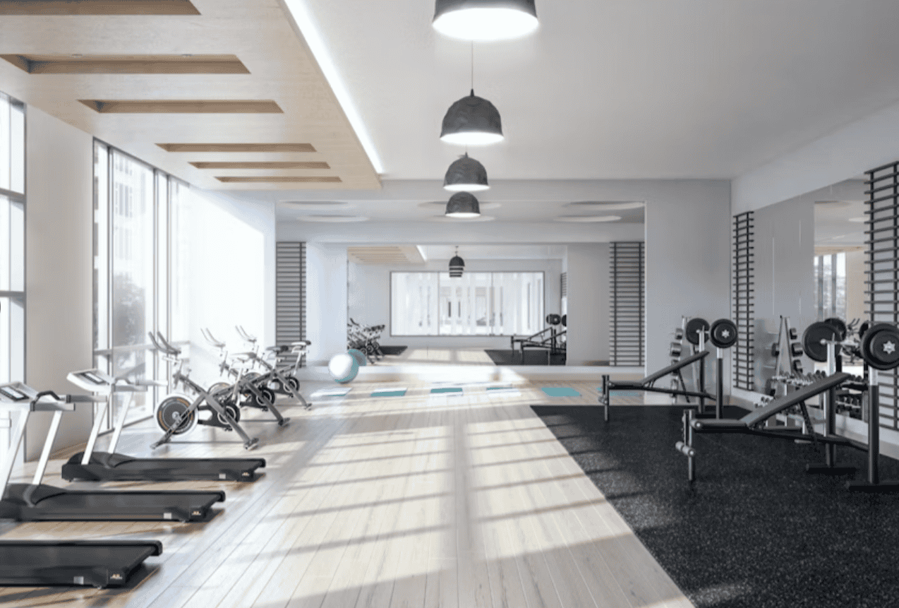 Modern fitness centre with cardio machines and weight training equipment at Orca Realty Inc. offering premium commercial space in a well-equipped wellness facility.