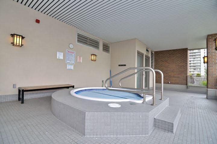 Hot tub on a residential apartment balcony with city view, outdoor relaxation space, and modern amenities. Perfect for tenants seeking comfort and leisure in urban settings.