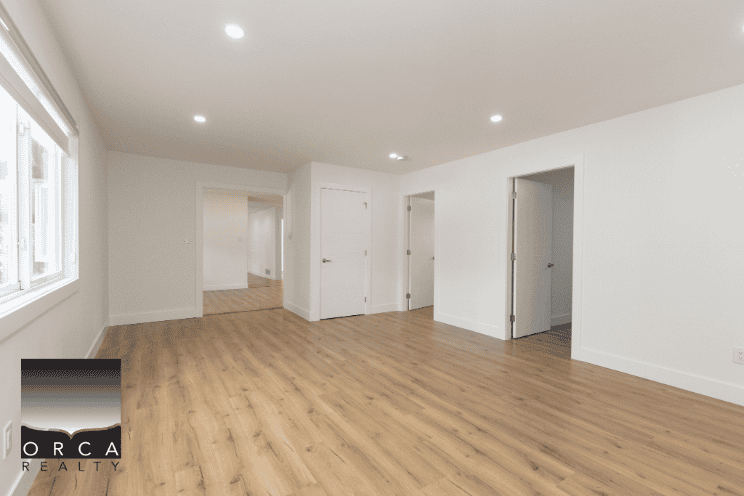 Spacious modern living room with hardwood floors, bright natural light, and white walls, ideal for homebuyers and real estate listings in Ontario.