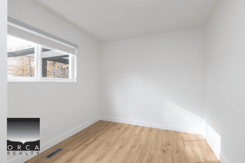 Bright vacant room with natural light, white walls, and hardwood floors, ideal for home or apartment rental, for sale, or real estate listings in Vancouver.