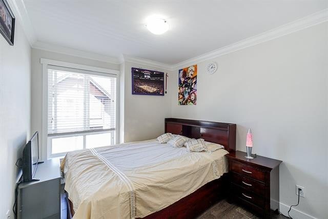 Bedroom with large window, minimalist decor, and modern furnishings in a Vancouver home for sale or rent.