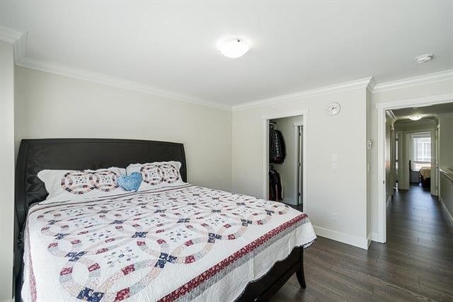 Spacious bedroom with a comfortable bed, modern decor, and closet space in a Vancouver-area home listed by Orca Realty Inc.