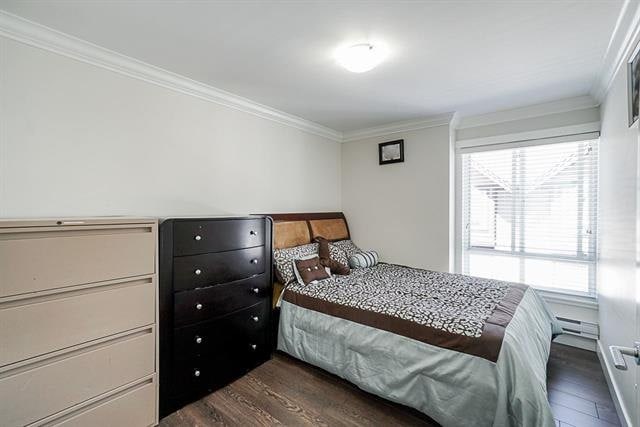 Modern bedroom with large window, stylish bedding, and storage furniture | Orca Realty Inc.