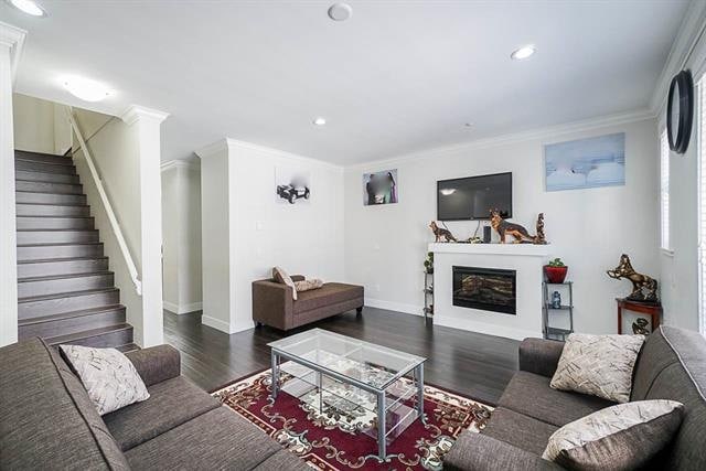 Modern living room with cozy sofas, fireplace, flat-screen TV, and contemporary decor in a property listed by Orca Realty Inc., Vancouver's trusted real estate experts.