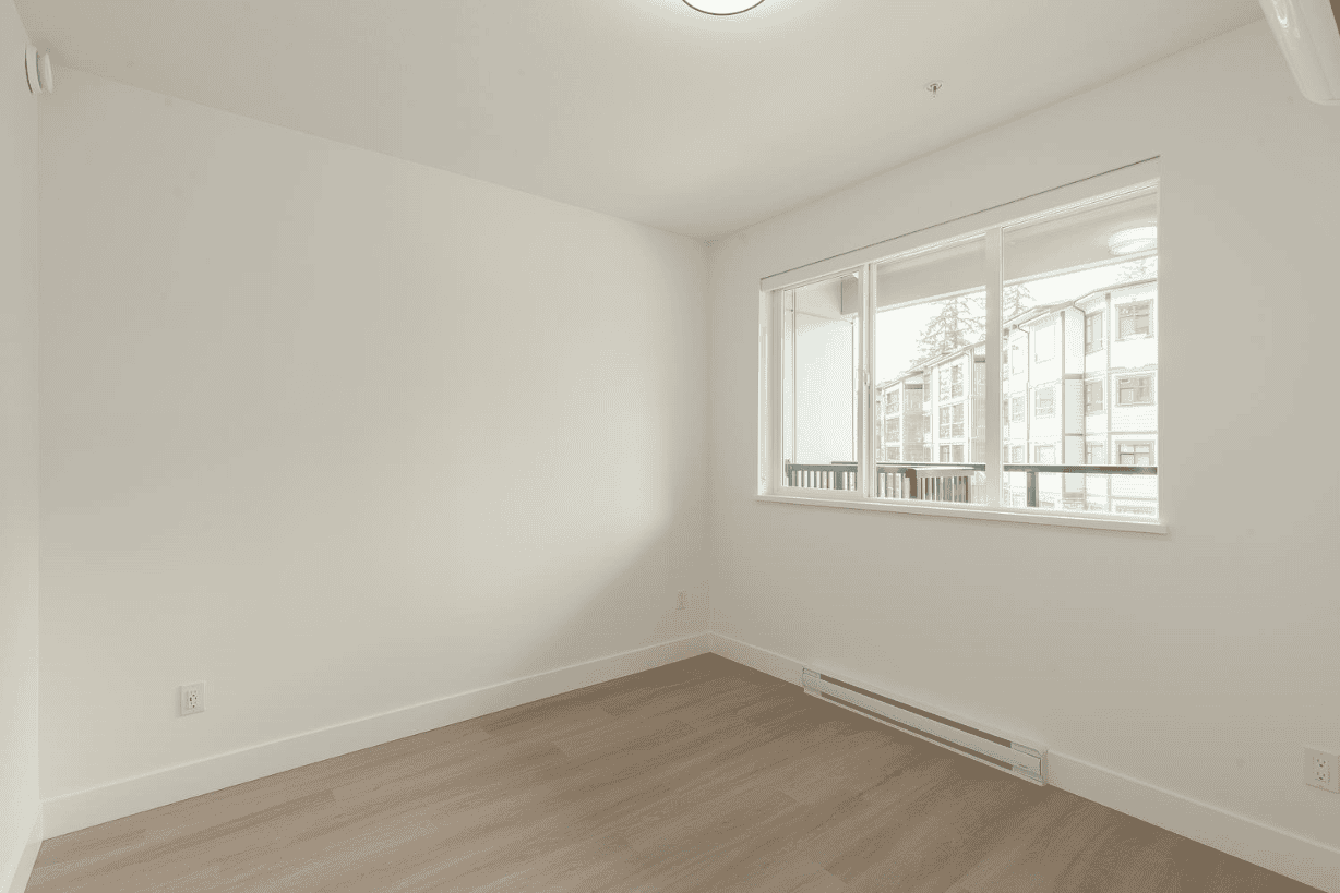 262951450-dca8ceb0-2bcd-4cd9-81b1-6fec9fa4cadd Bright and airy empty room with large windows in a modern apartment, ideal for real estate listings and property marketing in Vancouver.