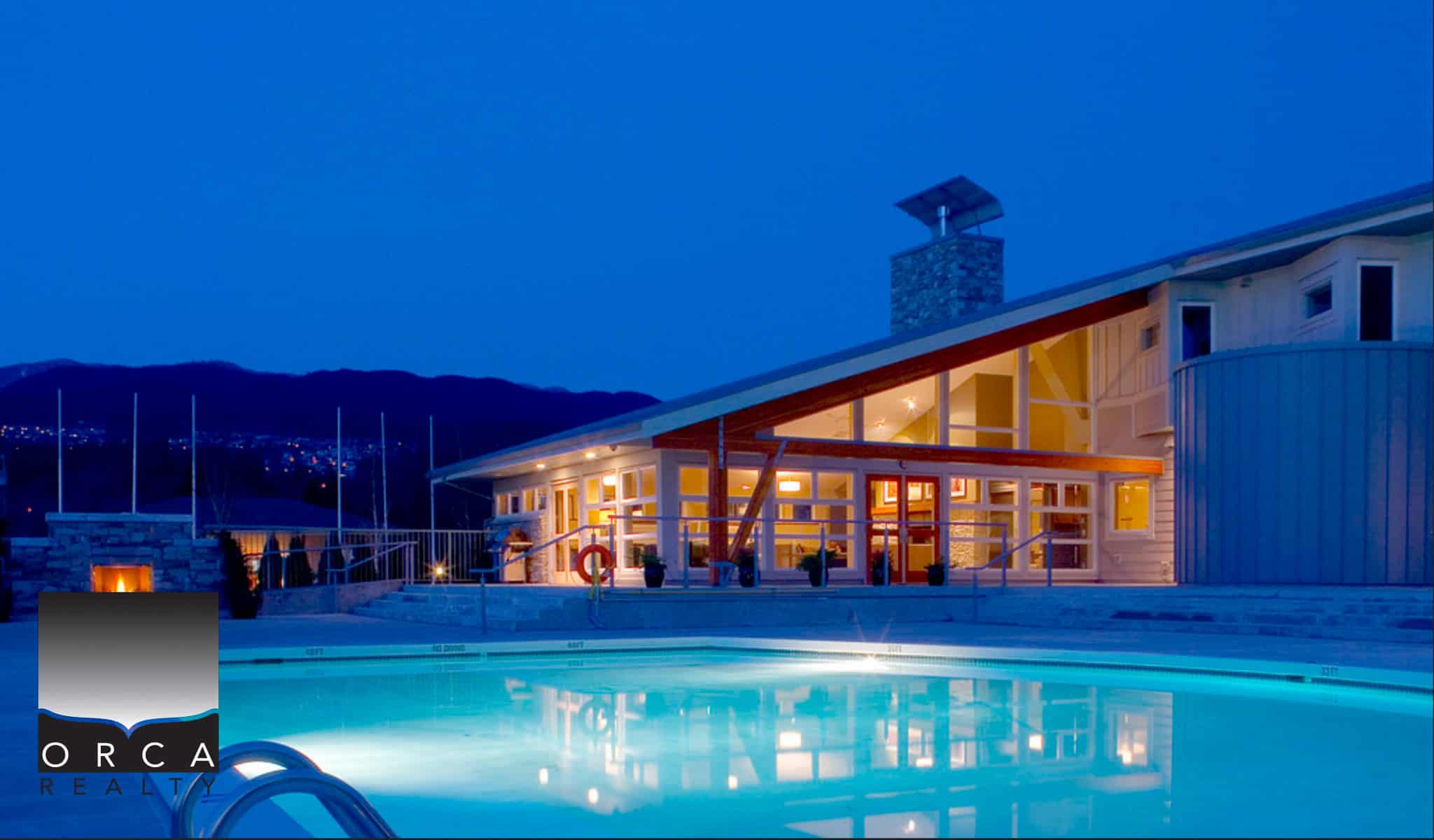 Luxurious waterfront home with pool, modern architecture, stunning mountain views, perfect for Vancouver Island real estate buyers.