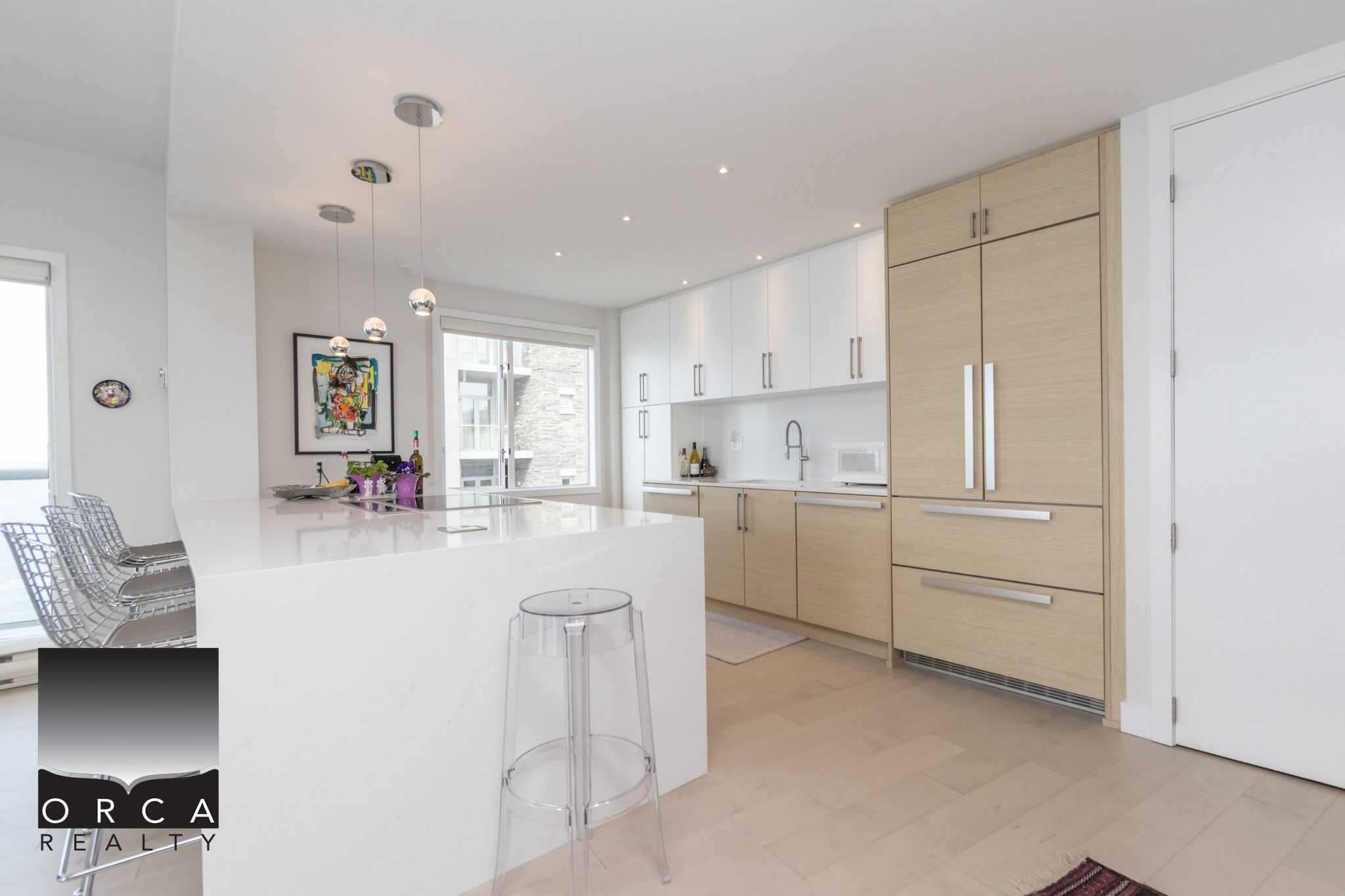 Modern Vancouver-style kitchen with white and light wood cabinetry, sleek countertops, and contemporary decor ideal for Vancouver real estate listings.