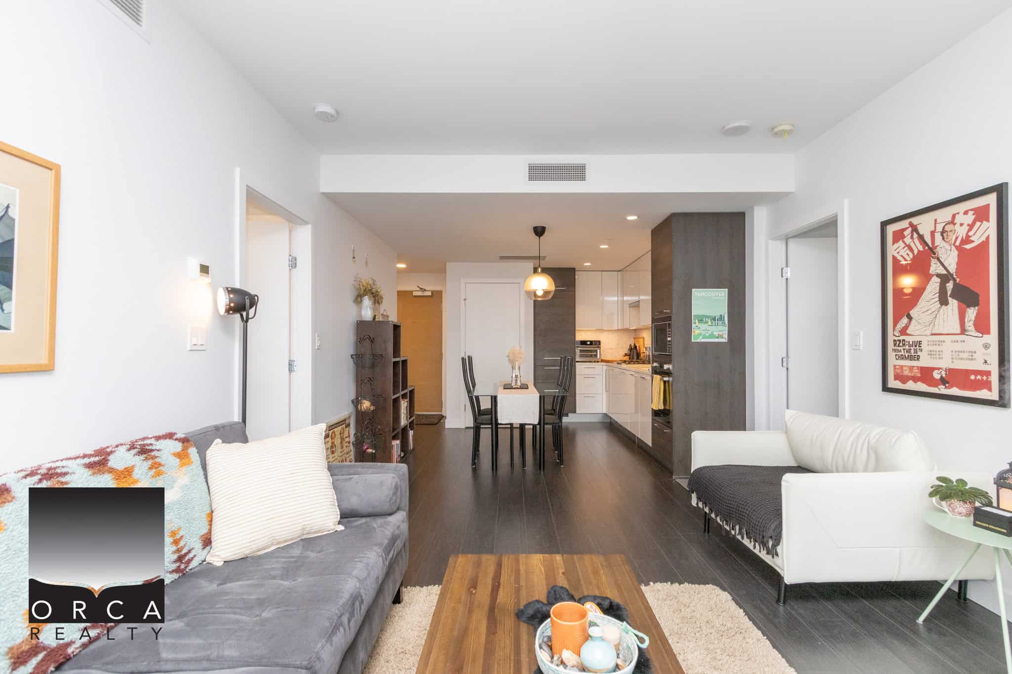 Bright modern living room with open-concept kitchen, stylish furniture, and contemporary decor, perfect for Vancouver real estate buyers and investors.