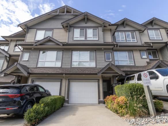 Modern multi-family townhome with attached garage, landscaped front yard, and contemporary architecture in a vibrant residential community – Orca Realty Inc.