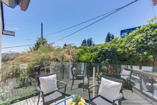 Balcony view with outdoor furniture and lush greenery, waterfront property, tranquil outdoor space, Vancouver real estate, Orca Realty Inc.