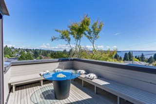 Deck with outdoor seating and scenic water view, perfect for relaxing and entertaining in Vancouver BC.