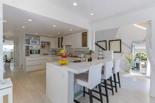 Kitchen interior with white cabinets and modern design in a bright open-concept home.