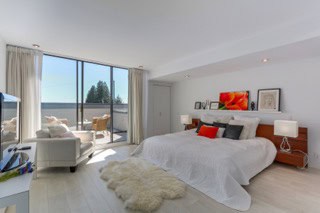 Luxury ocean-view bedroom with spacious layout and modern decor, showcasing stunning natural sunlight and serene harbour views. Perfect for upscale real estate listings in Vancouver.