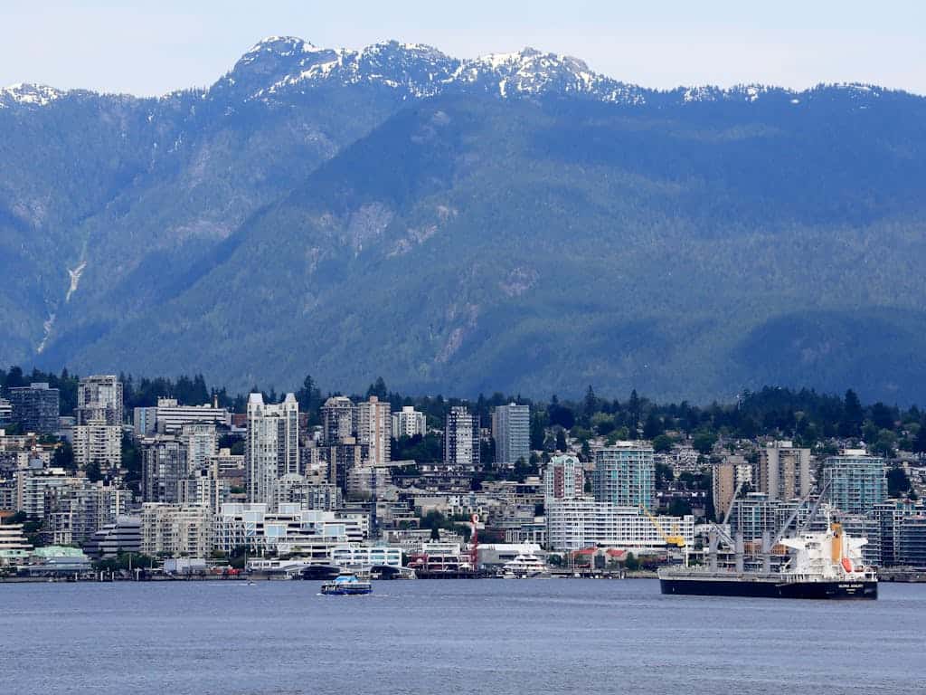 Vancouver skyline with mountains and waterfront, showcasing urban development and natural beauty, ideal for real estate and coastal property investments in BC.