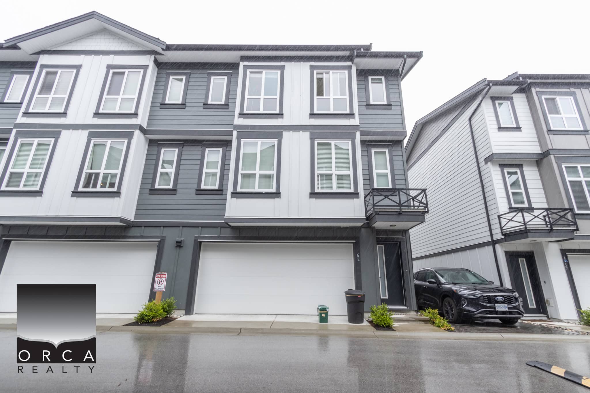 Modern multi-storey townhouse with sleek grey and white exterior, private balconies, and a spacious garage, ideal for Vancouver real estate buyers seeking contemporary city living.