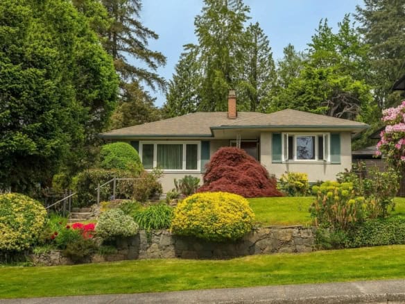 Comfortable single-family home with lush landscaped garden, mature trees, and vibrant flower beds, ideal for Vancouver Island living. Perfect property for families seeking a welcoming suburban residence.