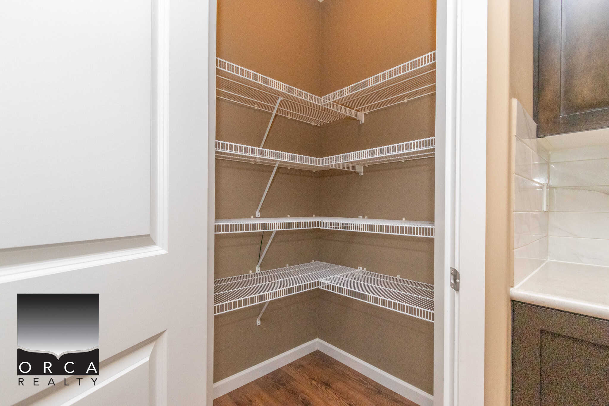 Spacious walk-in pantry with adjustable wire shelves, ideal for kitchen storage and organization. Located in a modern home, perfect for homeowners seeking functional and accessible pantry space.