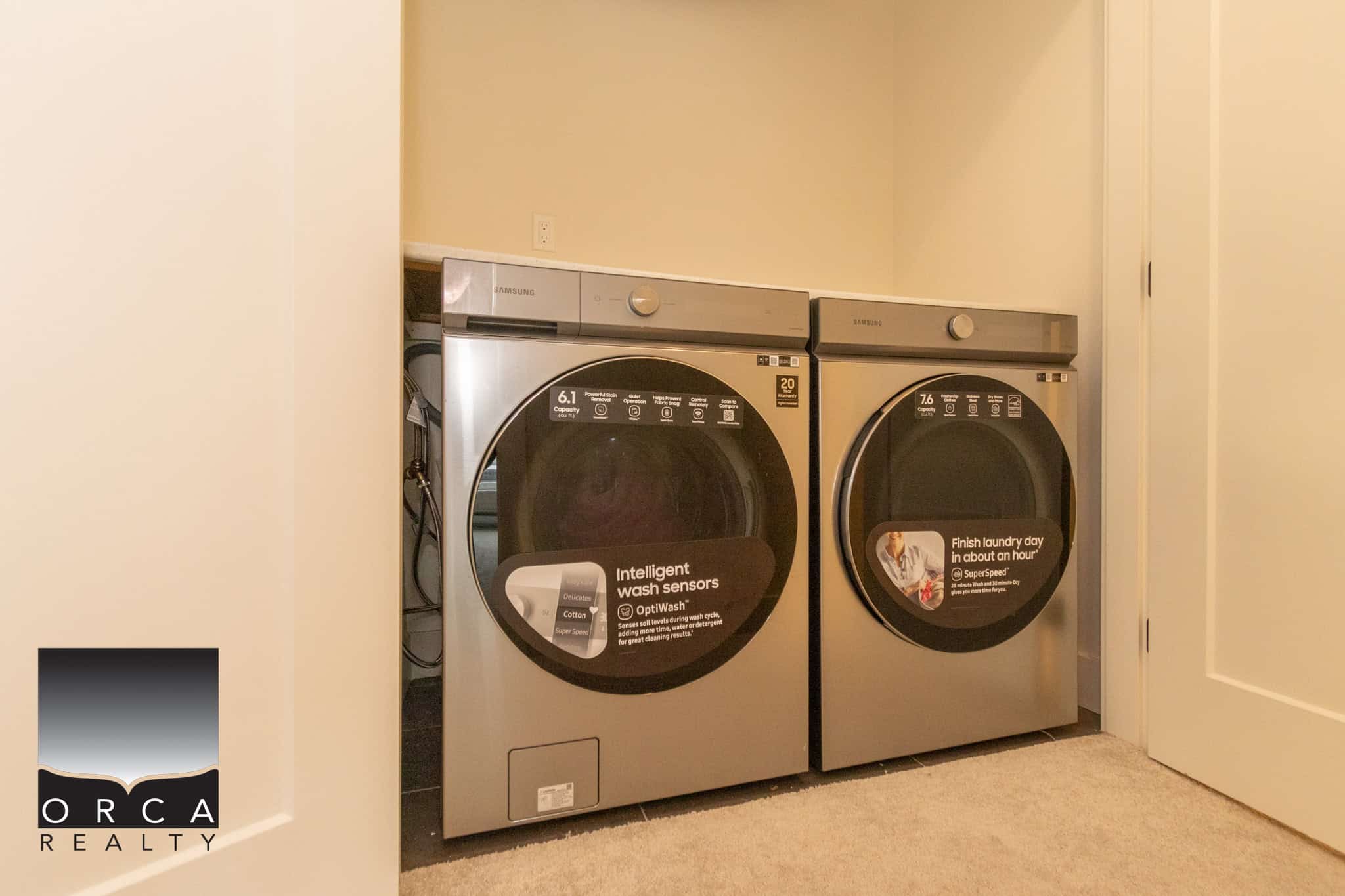 Modern stainless steel washer and dryer set in a laundry room, ideal for residential real estate in Vancouver, BC, showcasing convenient home amenities.