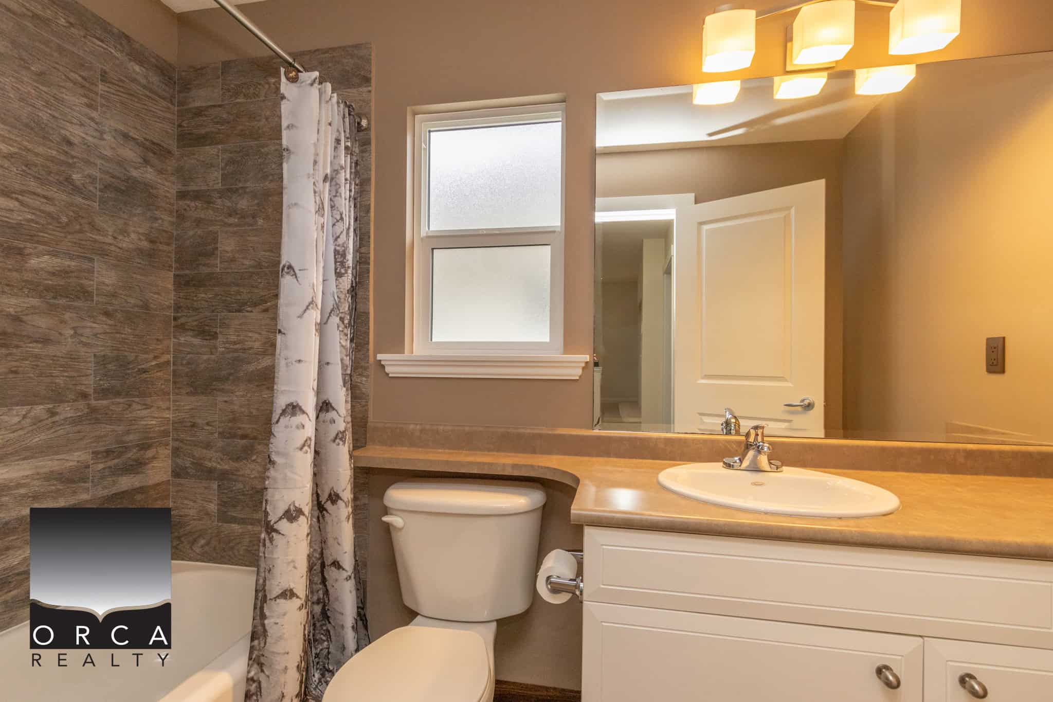 Spacious bathroom with modern fixtures, neutral tones, and natural lighting, ideal for Vancouver real estate buyers.