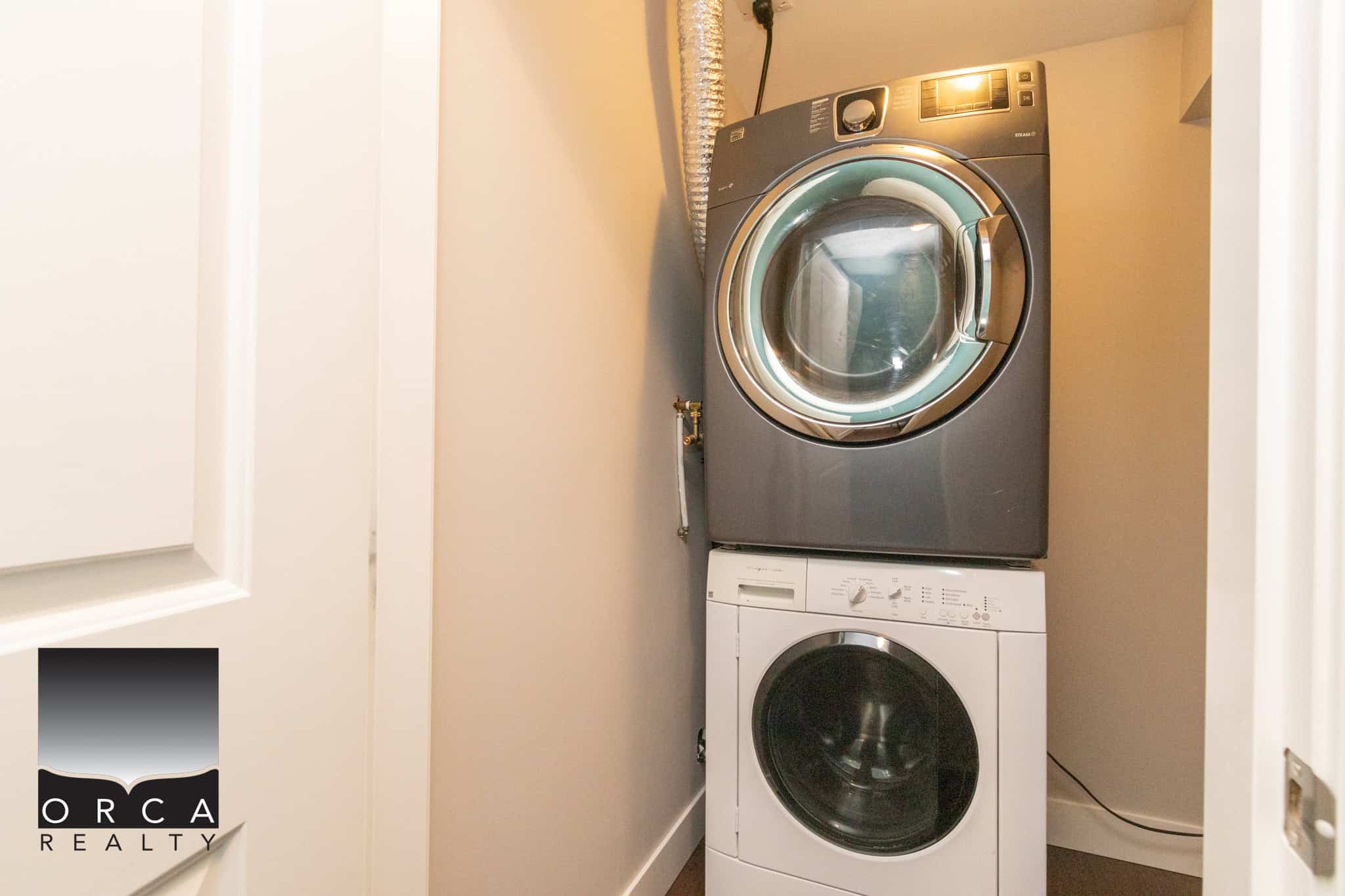 Stacked front-loading washer and dryer in a laundry room, modern appliances for easy home organization and efficient laundry.