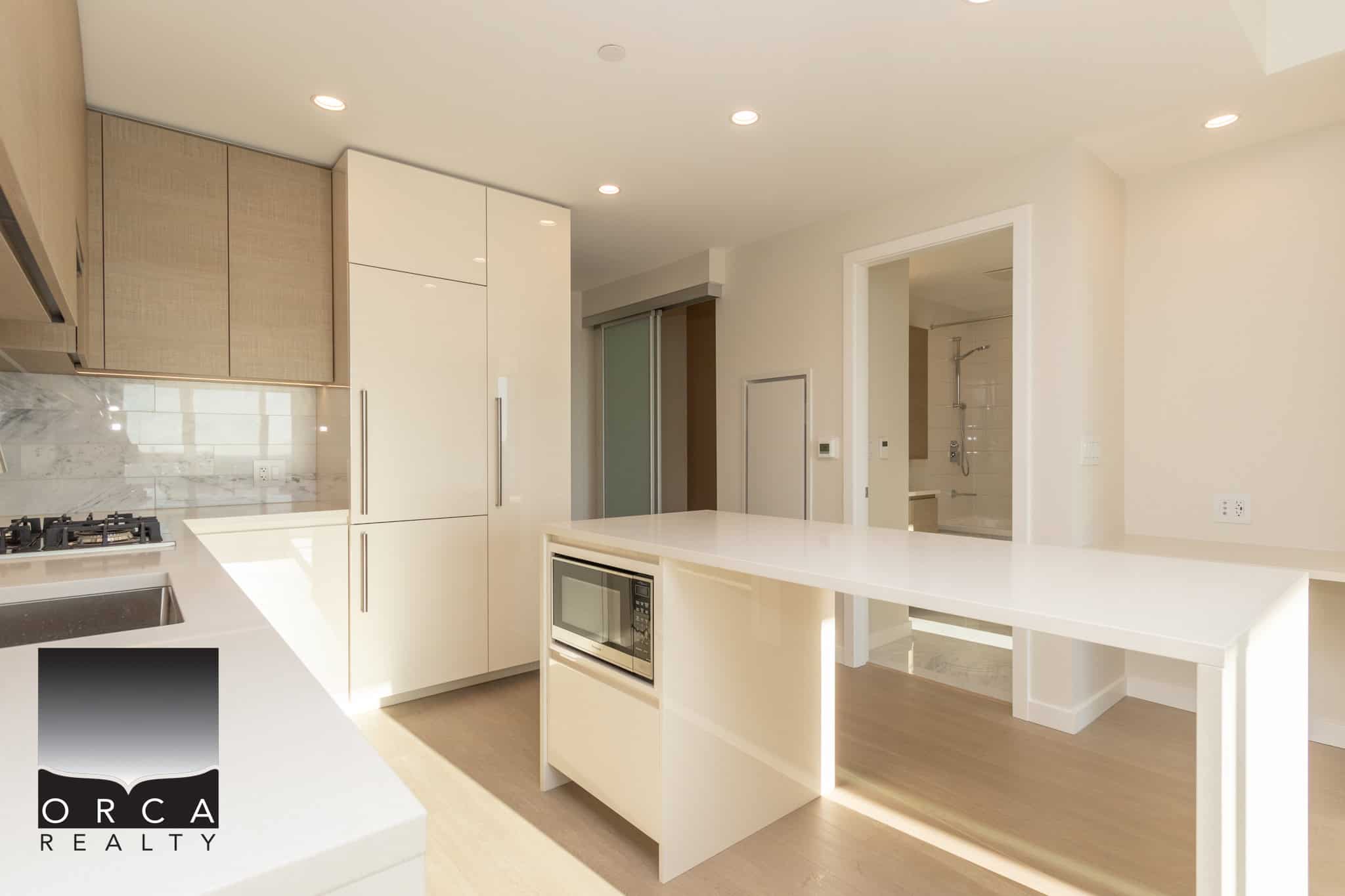 Bright modern kitchen with white cabinetry, integrated appliances, and natural light, perfect for Vancouver lifestyle homes.