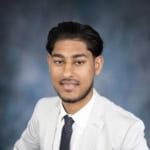 Professional real estate agent portrait in formal attire, showcasing expertise in Vancouver Island real estate market, serving buyers and sellers with trusted property services.