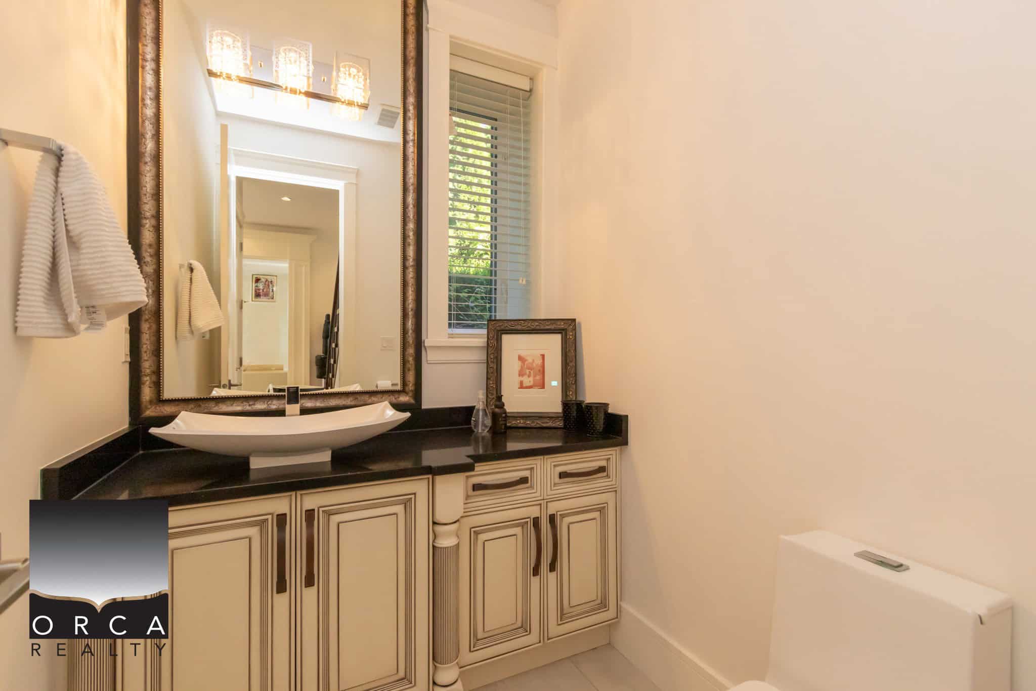 Luxurious bathroom in a modern home with elegant vanity, stylish mirror, and tasteful decor, perfect for showcasing upscale real estate listings in Vancouver by Orca Realty Inc.