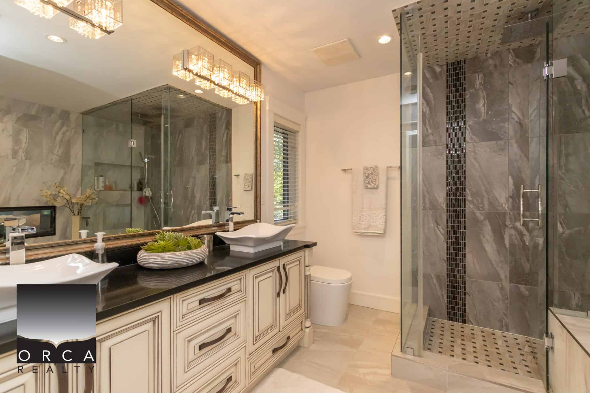 Luxurious modern bathroom with dual vessel sinks, elegant marble accents, spacious walk-in shower, and contemporary fixtures in a high-end Vancouver home.