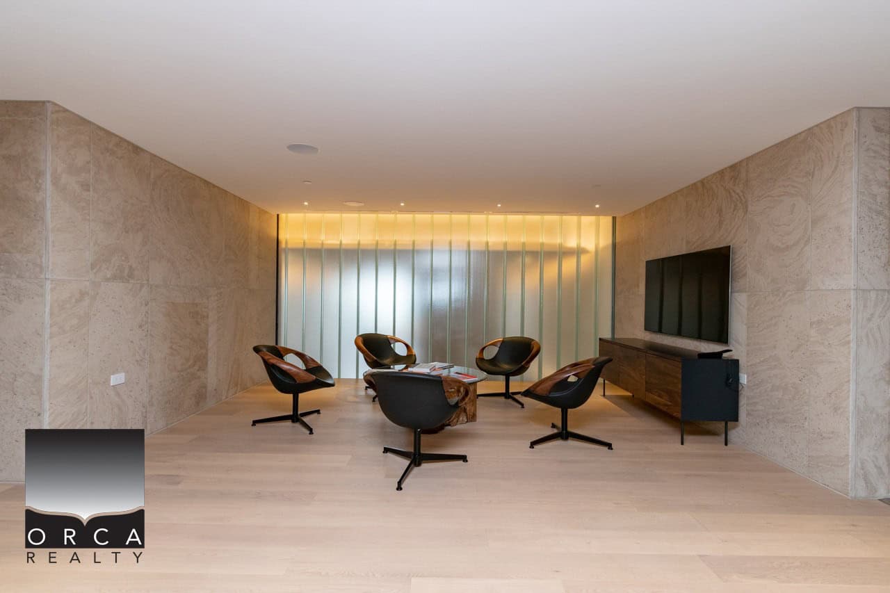 Contemporary modern office space with stylish chairs, sleek wood accents, and a minimalist design for professional real estate meetings and client consultations.