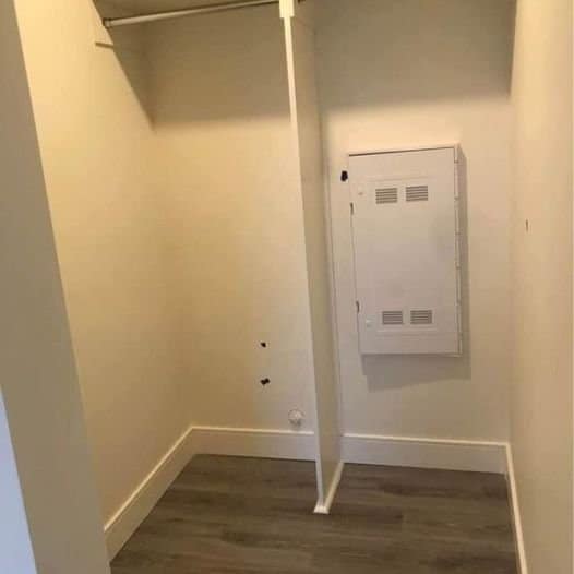 Electrical panel in a small storage closet, ideal for organized utility access.