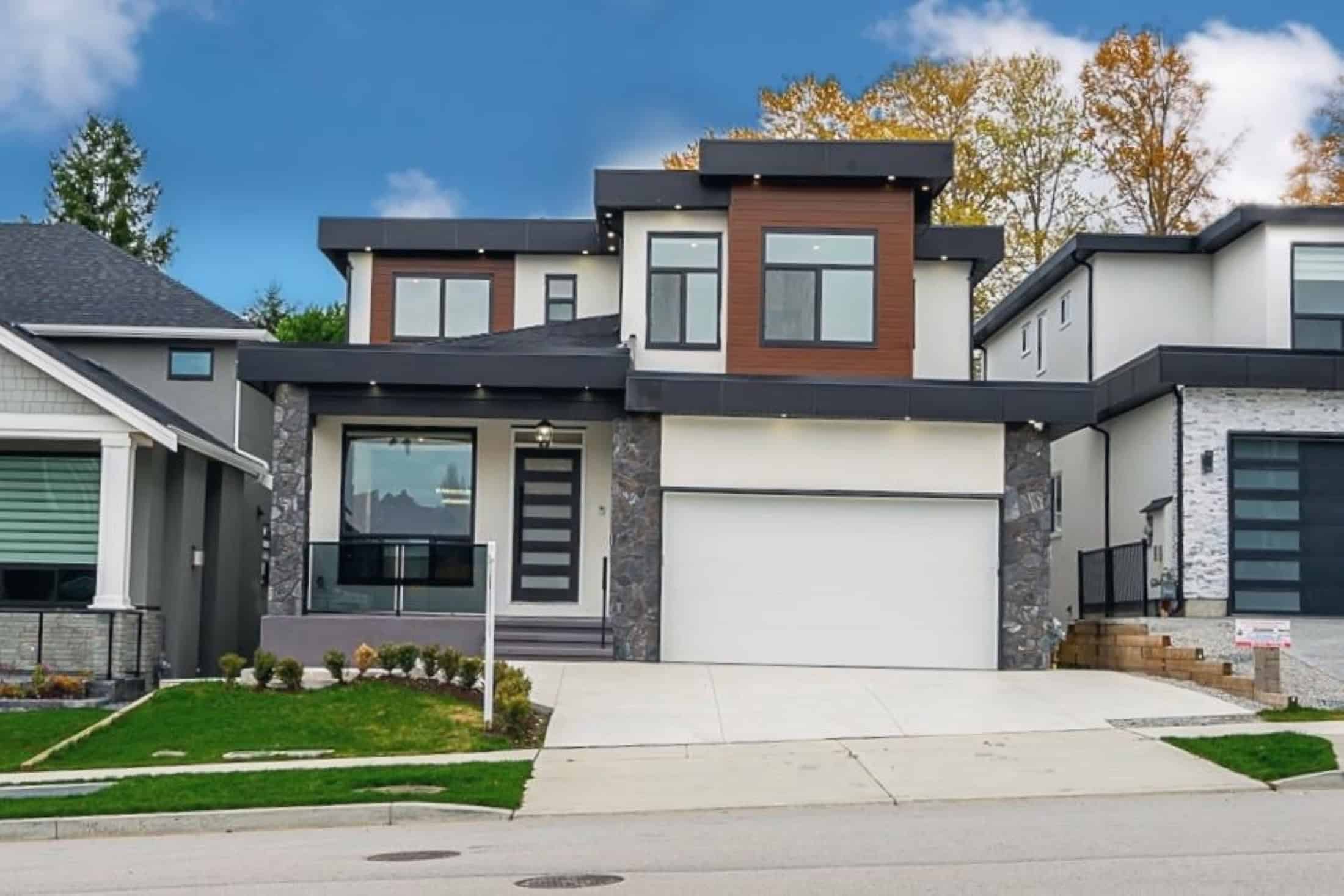 Contemporary modern house exterior showcasing stylish architecture, large windows, and a landscaped front yard, representing upscale real estate for sale or lease by Orca Realty Inc.