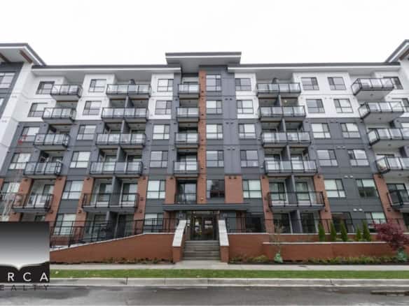 Contemporary multi-storey residential building with modern architecture, balconies, and landscaped surroundings, showcasing Orca Realty Inc.’s expertise in Vancouver real estate.