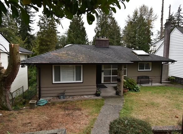 Charming single-family home with a manicured lawn and mature trees in a quiet neighbourhood, ideal for families and investors seeking Vancouver Island real estate opportunities.