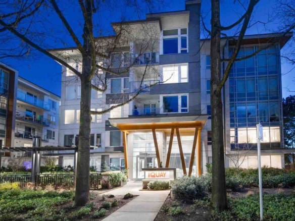 Modern residential building in Vancouver with contemporary architecture, including glass facades and stylish entrance, perfect for urban living.