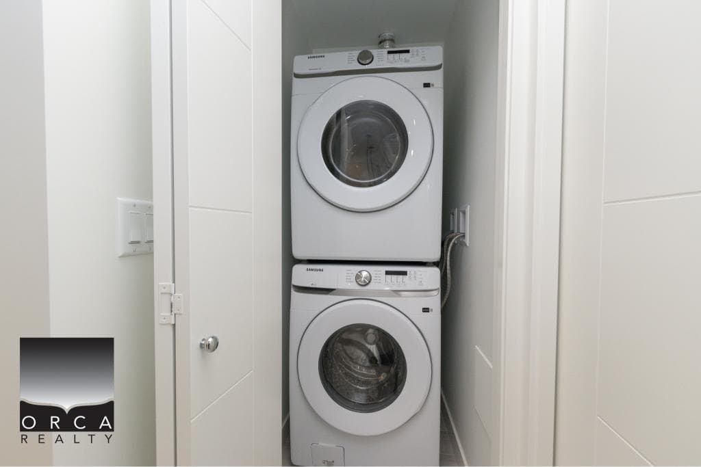 Stacked washer and dryer in a laundry closet, modern home appliances, clean and efficient utility space for residential property in Canada.