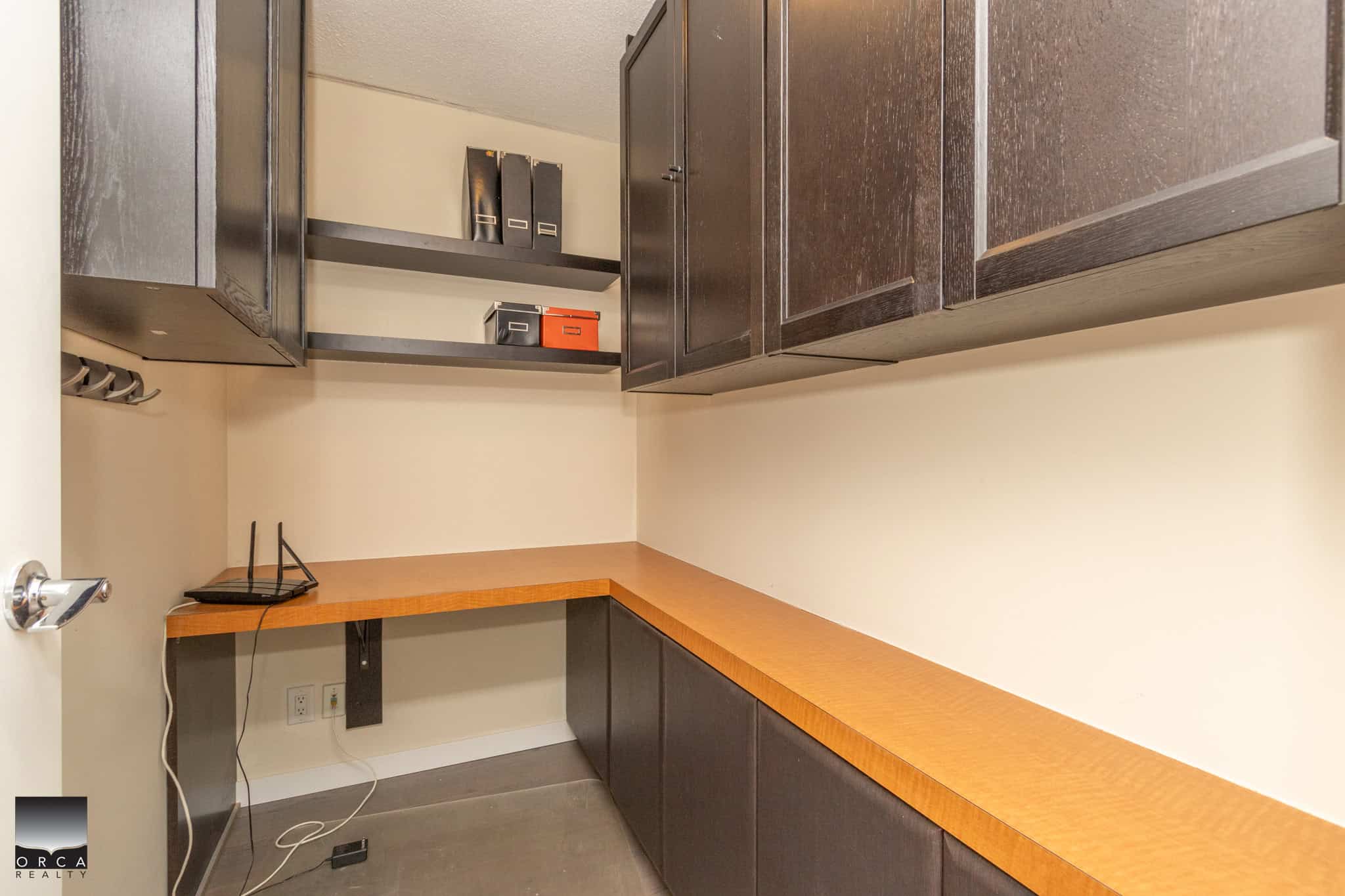 Modern office storage with dark wood cabinets and open shelving, ideal for organization and workspace in BC real estate offices.