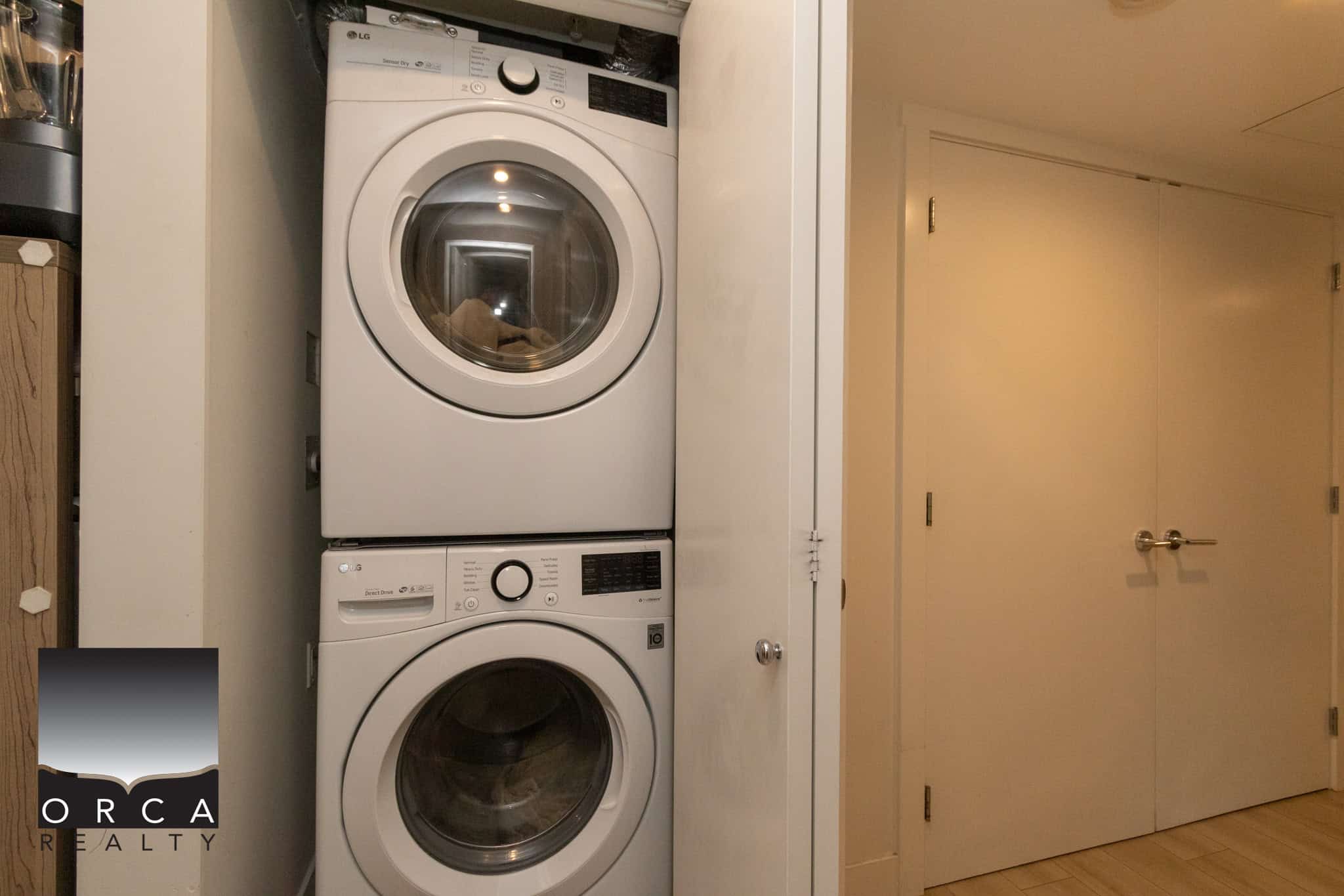 Stacked front-loading washer and dryer in a laundry closet.