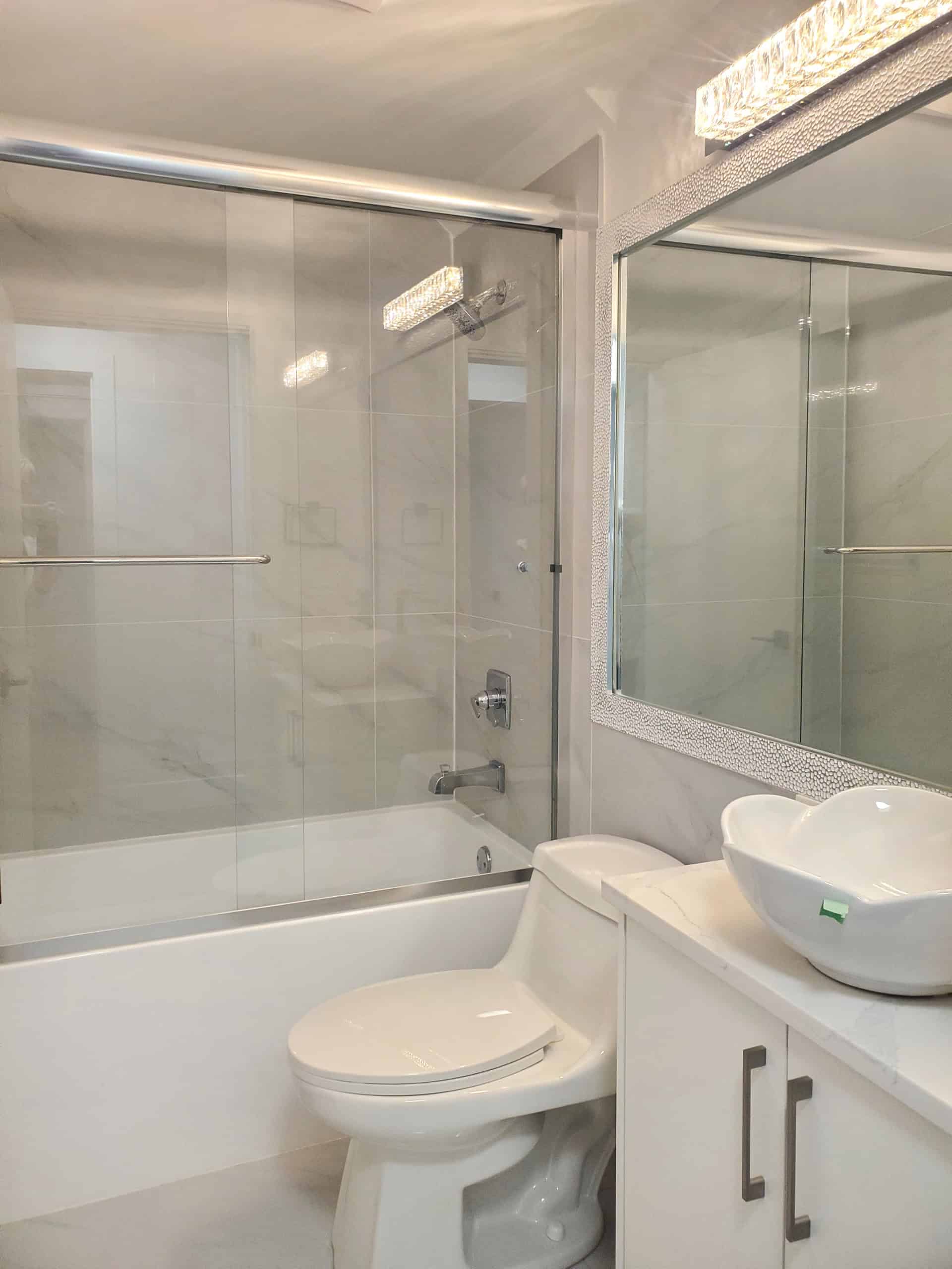 15 Modern bathroom with glass-enclosed shower, sleek white fixtures, and a stylish vessel sink, offering a contemporary and functional space ideal for Vancouver real estate.
