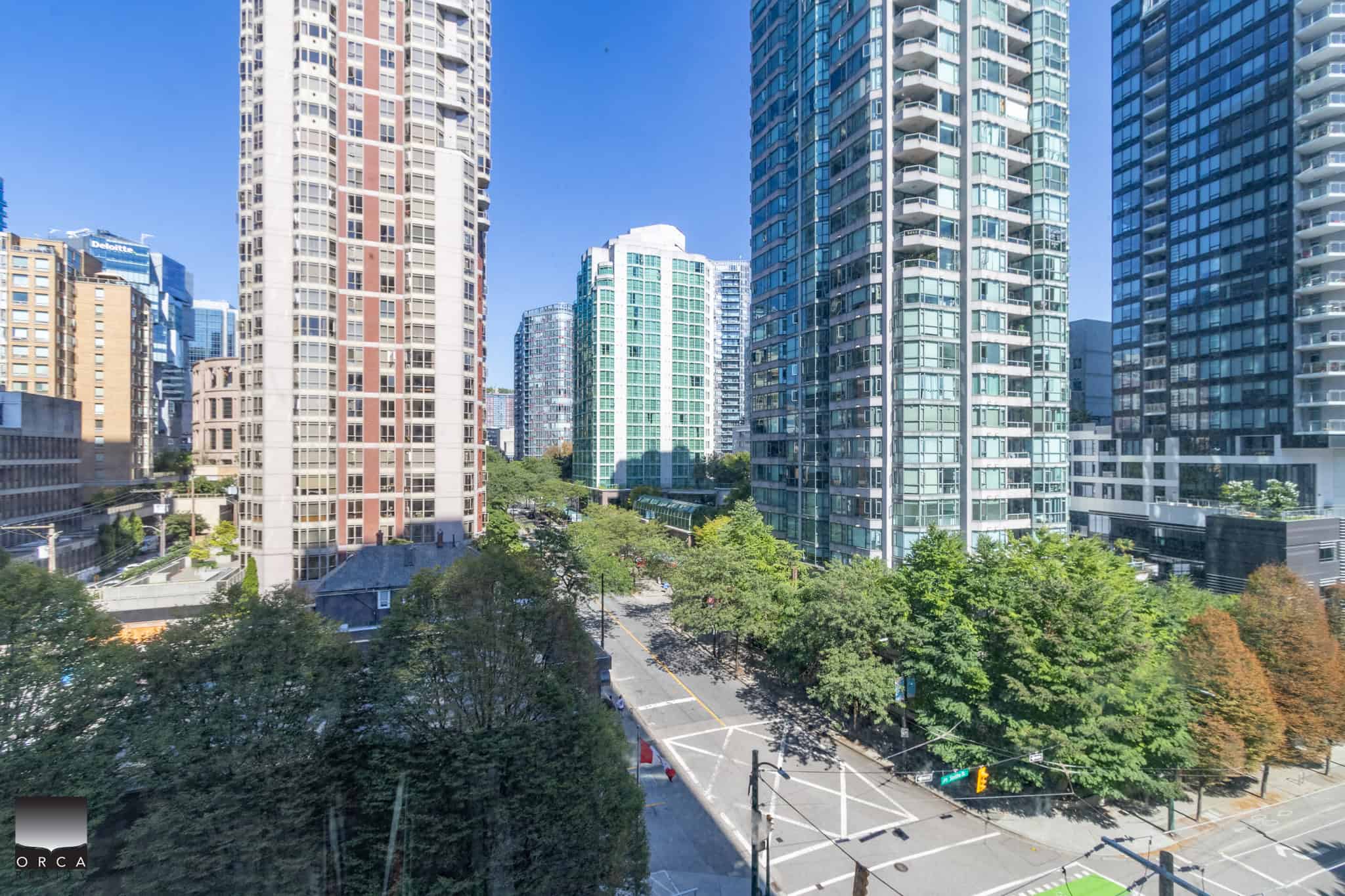 Modern downtown Vancouver cityscape featuring high-rise residential buildings and lush green trees, ideal for real estate investment and urban living opportunities in BC.