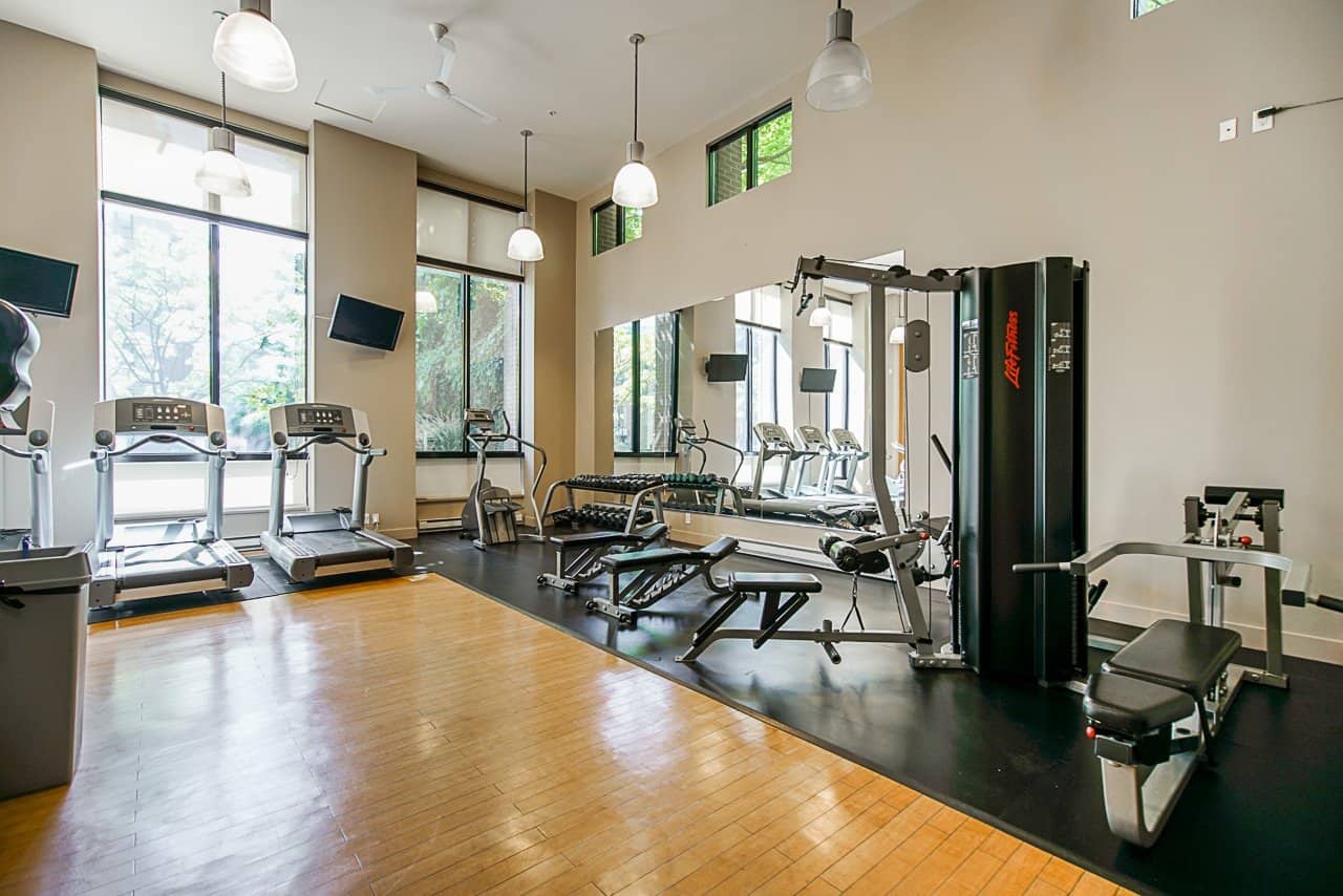 Modern commercial gym interior with cardio and strength training equipment at Orca Realty Inc., showcasing a professional fitness facility in a bright, spacious setting.
