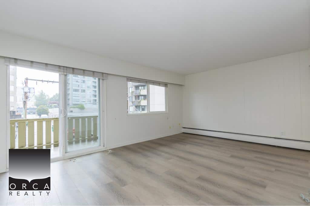 Bright spacious living room with large windows, balcony access, and modern minimalist decor, ideal for Vancouver condo living.
