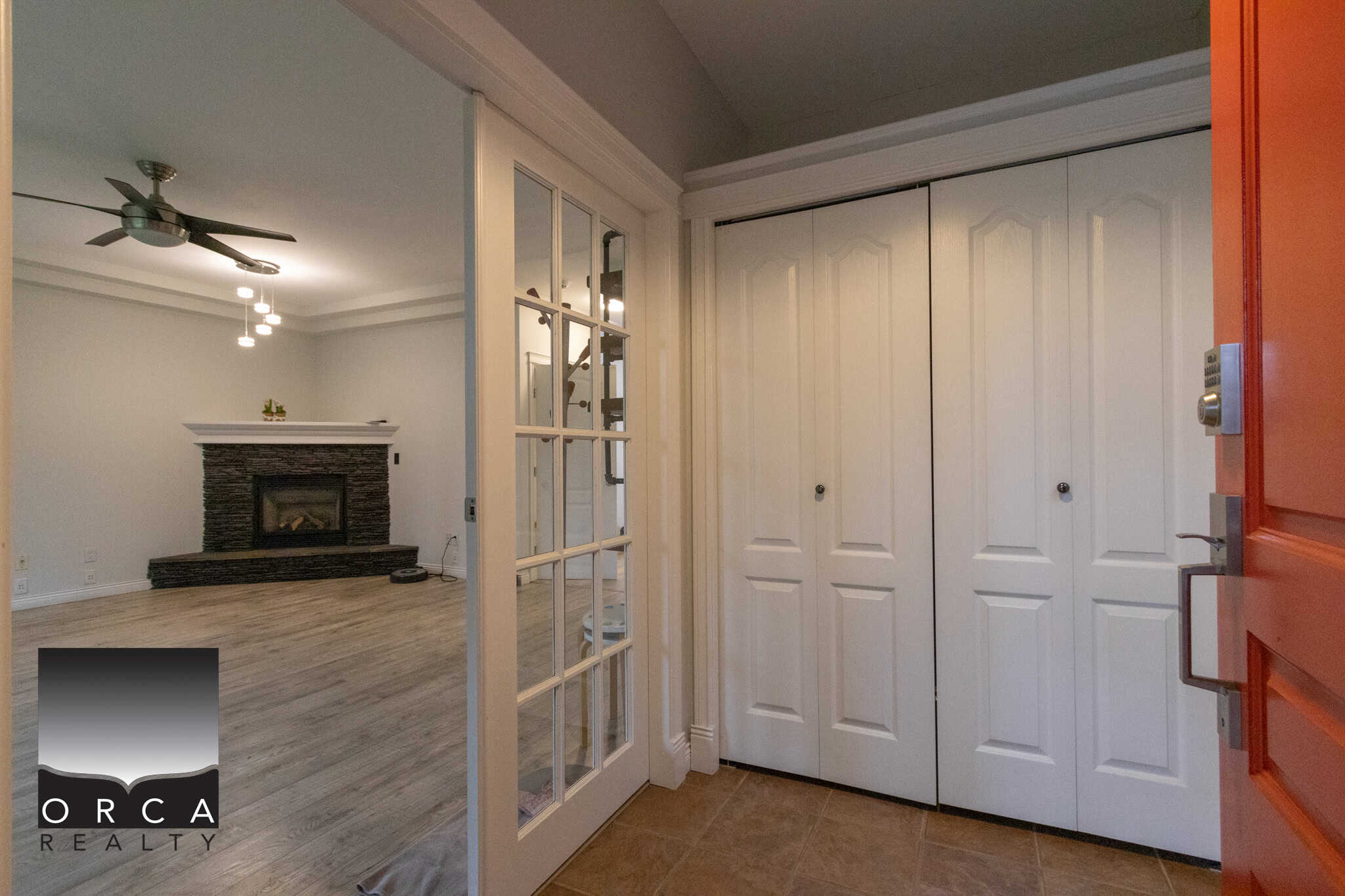 Spacious living room with modern fireplace, hardwood flooring, and contemporary lighting, showcasing a cozy and stylish home interior.